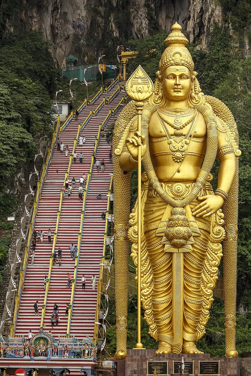 Tượng thần Murugan sơn vàng, cao 42,7 mét, bên bậc thang lên động Batu, Malaysia. Tượng mới, khánh thành năm 2006.