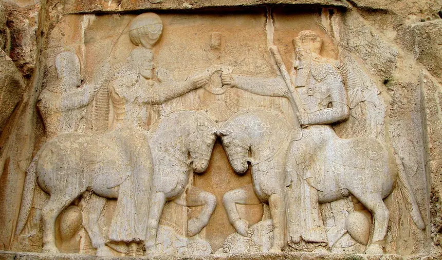 Phù điêu vua Ardashir I nhận vòng vương quyền, Naqsh-e Rostam, Iran, thế kỷ 3. Theo chú thích của tệp ảnh, người cưỡi ngựa đội mũ cao bên phải là Ohrmazd (Ahura Mazda), bên trái là nhà vua. Đây là nghệ thuật của triều đình, không phải tượng thờ.