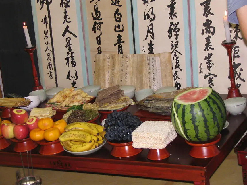Bàn lễ jesa dịp Chuseok (Tết Trung thu) ở Hàn Quốc, phía sau là bức bình phong chữ viết. Ảnh chụp năm 2005.