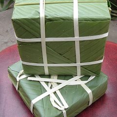 Green square sticky-rice cake (banh chung), cylindrical banh tet or sweet pastries